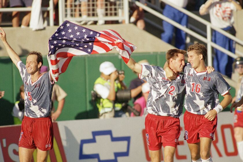 United States players Thomas Dooley, left, Mike Lapper, middle, and Mike Sorber celebrate their 2-1 upset victory over the Colombian team during the World Cup soccer championship Group A first round match at the Rose Bowl in Pasadena, Calif., June 22, 1994. (AP Photo/Lois Bernstein)