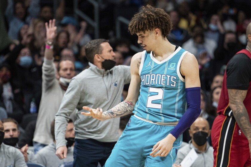 Charlotte Hornets guard LaMelo Ball (2) reacts after making a 3-point shot against the Miami Heat during the first half of an NBA basketball game in Charlotte, N.C., Saturday, Feb. 5, 2022. (AP Photo/Jacob Kupferman)
