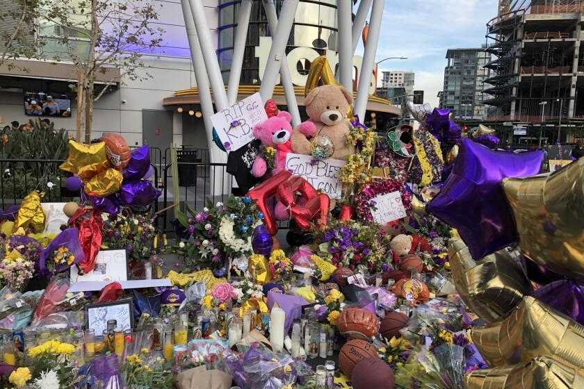 Tributes to Kobe Bryant, his daughter Gianna and the other seven victims of a helicopter crash Sunday that killed the Lakers legend are seen outside Staples Center and L.A. Live.