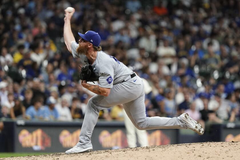 Los Angeles Dodgers' Michael Kopech pitches during the eighth inning of a baseball game against the Milwaukee Brewers, Monday, Aug. 12, 2024, in Milwaukee. (AP Photo/Aaron Gash)