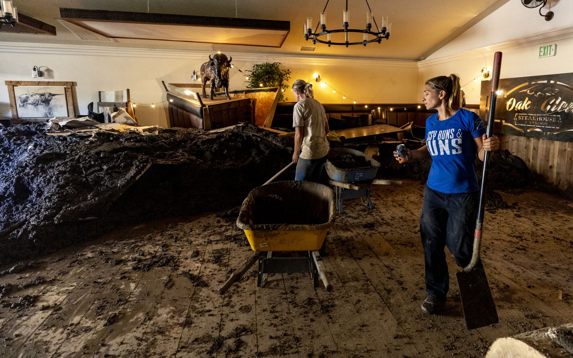 Two people in a room with mud four feet high