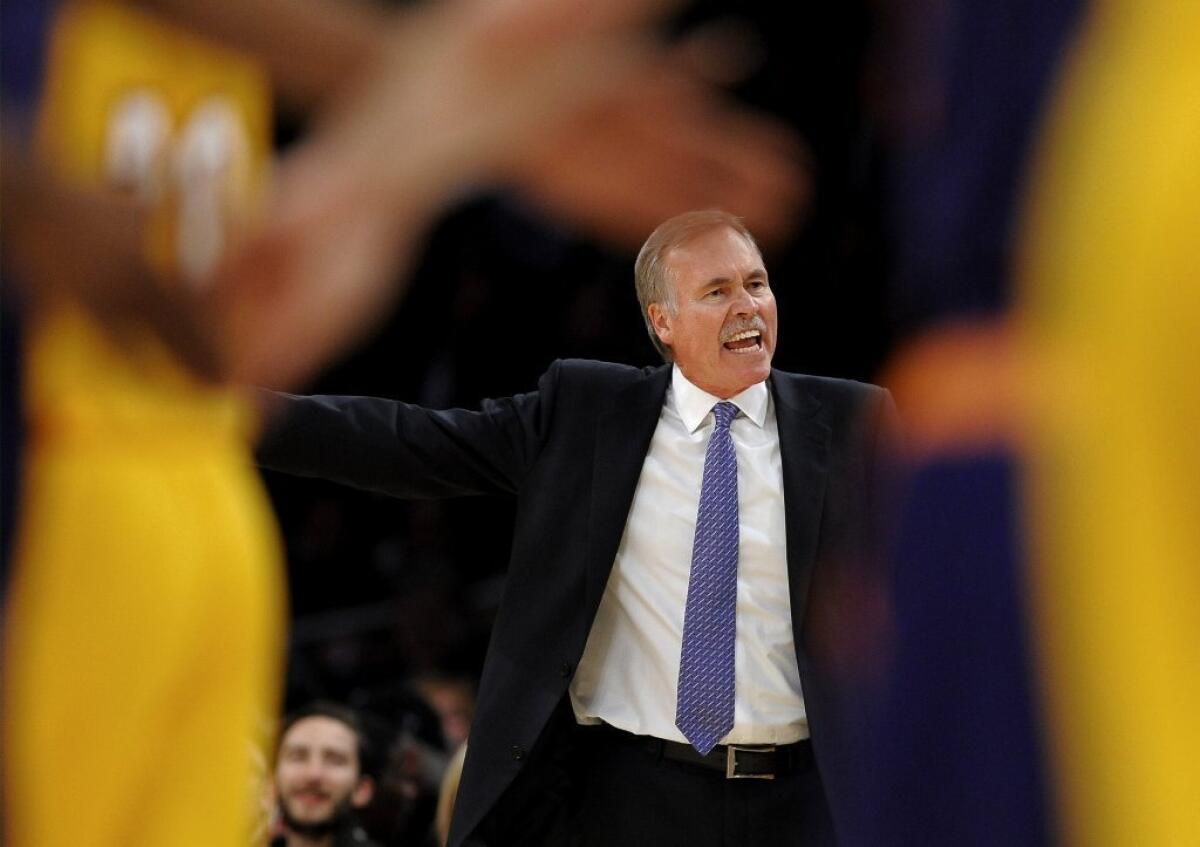 Lakers Coach Mike D'Antoni talks to his team during a game against the Phoenix Suns.