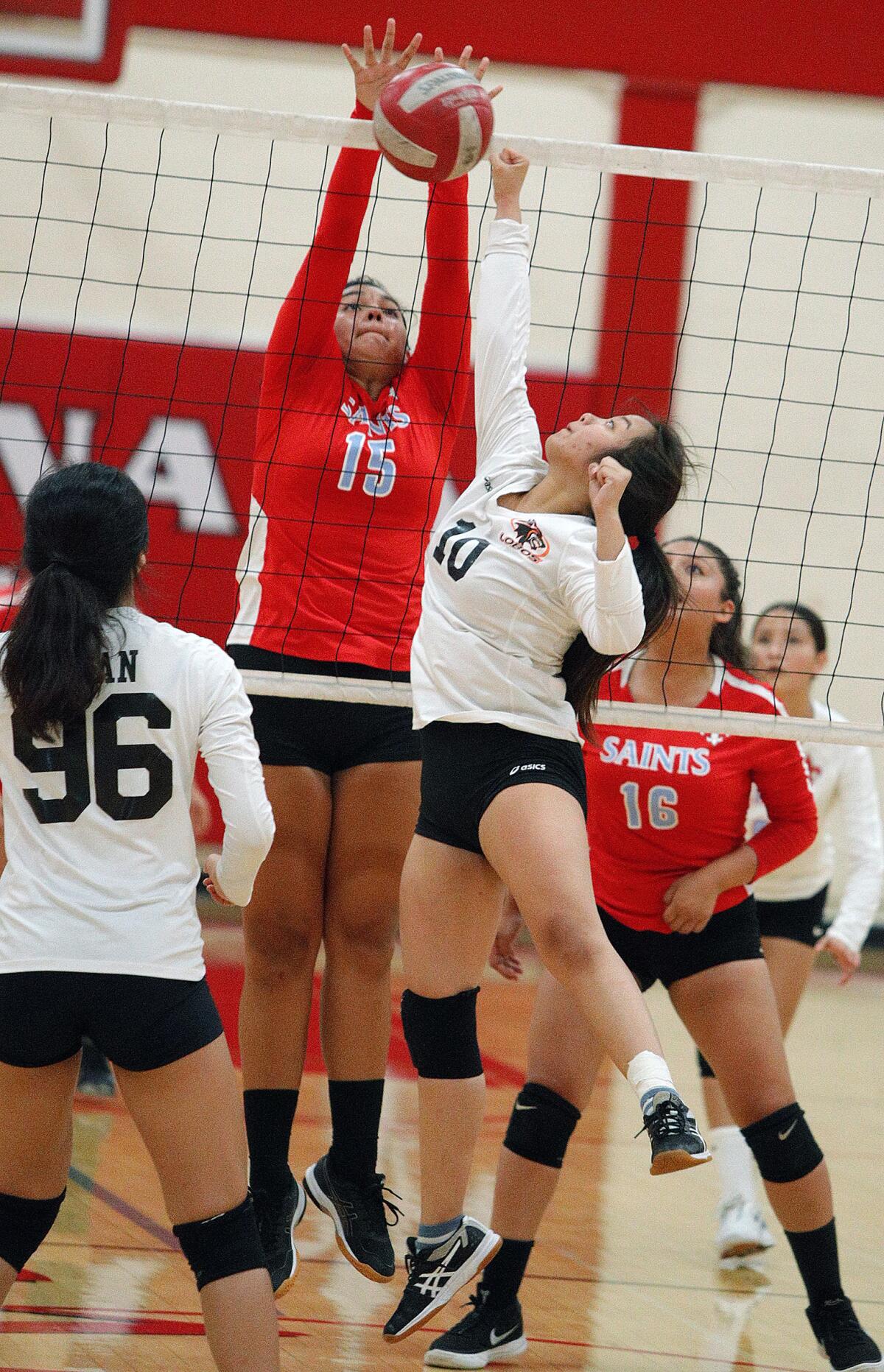 Los Amigos' Katie Mai, right, battles at the net with Santa Ana's Alessandra Caldera in a nonleague match on the road Wednesday.