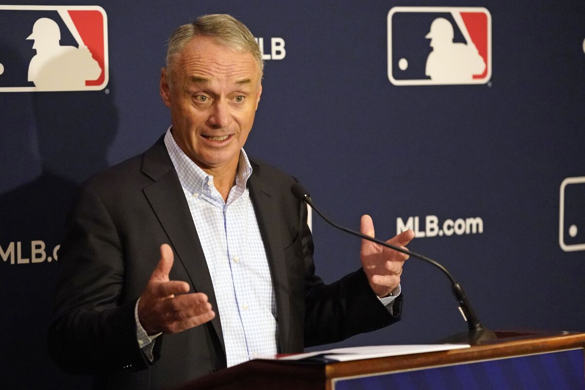 MLB commissioner Rob Manfred speaks from behind a podium during a news conference 