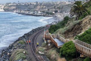 Workers investigate a landslide below Buena Vista that damaged the pedestrian beach trail and stopped rail service between Orange and San Diego counties in San Clemente, CA, on Thursday, January 25, 2024. (Photo by Jeff Gritchen, Orange County Register/SCNG)