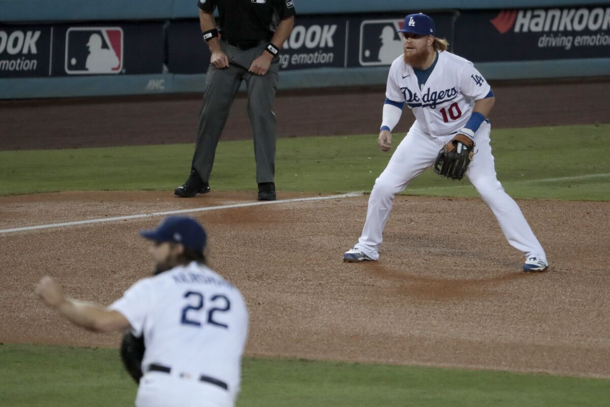 Dodgers third baseman Justin Turner keeps a close eye on the batter as Clayton Kershaw delivers a pitch.
