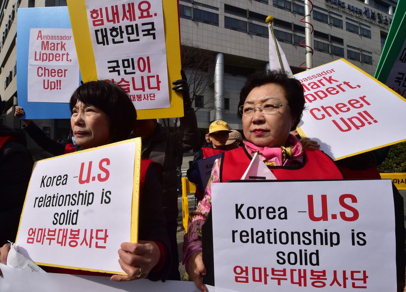 South Korean women show support for the U.S. outside a hospital where Mark Lippert was treated after the attack.