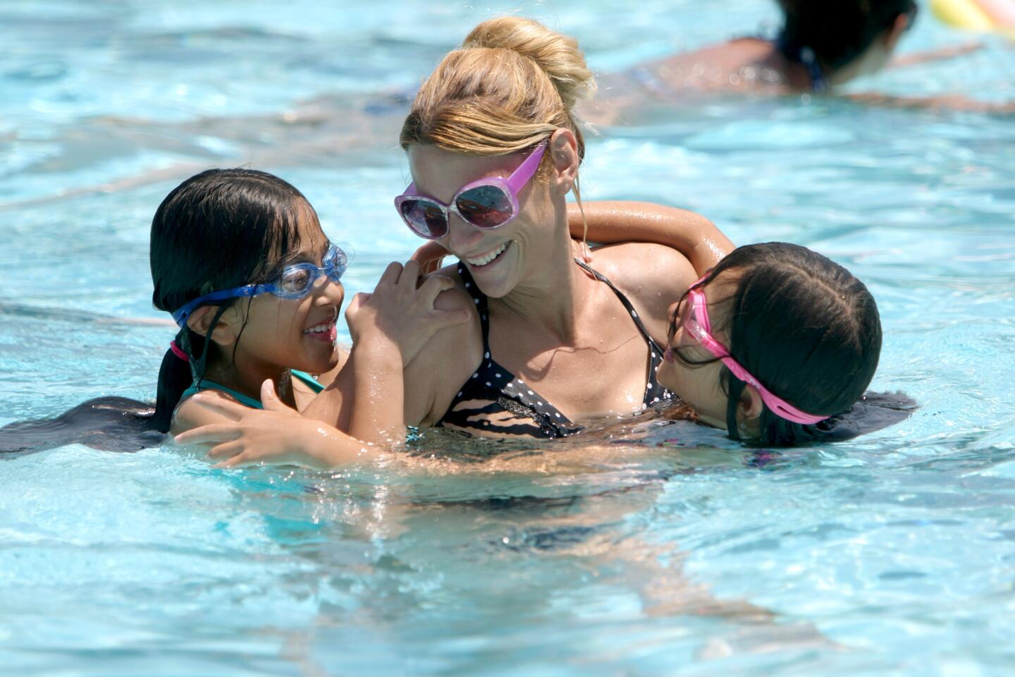 Maja Daoust of Glendale plays with her daughters, Momo Nakazawa, left, and Mami Nakazawa, right, during open swim at the Pacific Park pool on Tuesday, June 21, 2016.