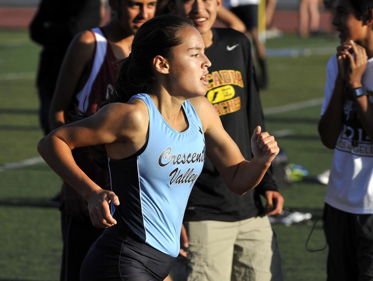 Crescenta Valley's Megan Melnyk, one of 20 entrants from the area in the CIF Southern Section Track and Field Divisional Championships, on her way to the finish in a Pacific League finals track meet at Arcadia High School on Friday, May 9, 2014.