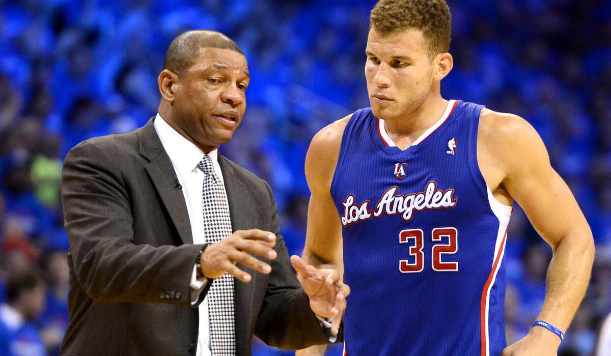 Clippers Coach Doc Rivers talks strategy with power forward Blake Griffin during a playoff game against the Thunder.
