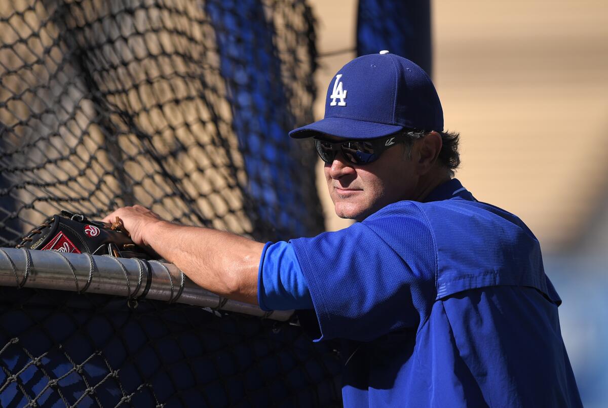 Dodgers Manager Don Mattingly watches his club take batting practice before a game against the Rangers on June 18 at Dodger Stadium.
