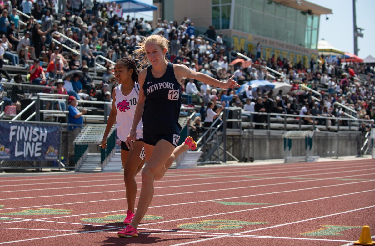 Newport Harbor's Keaton Robar crosses the finish line first in the 800 meters at the CIF Southern Section Masters Meet.