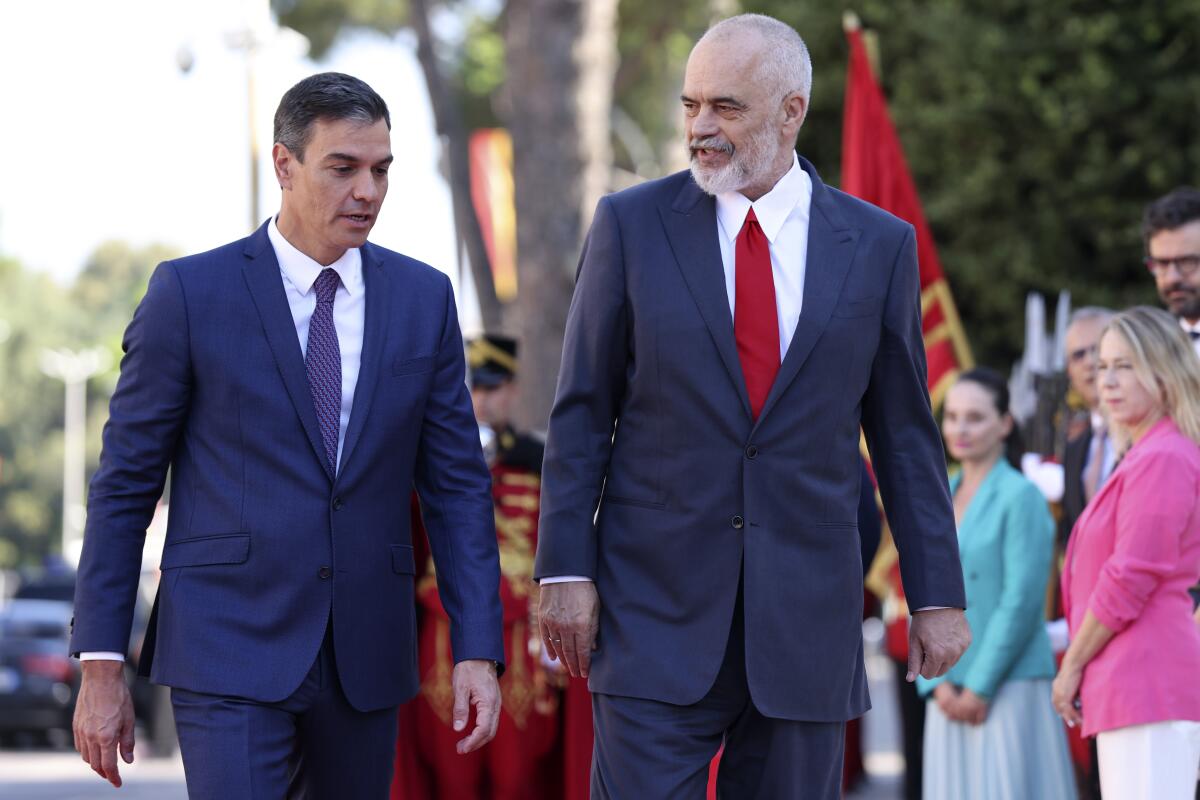 Spain's Prime Minister, Pedro Sanchez, left, and his Albanian counterpart Edi Rama talk during the welcoming ceremony at the government headquarters in Tirana, Albania, Monday, Aug. 1, 2022. Sanchez is in Albania for a one-day official visit. (AP Photo/Franc Zhurda)