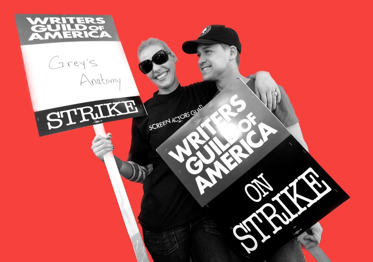 Actors Katherine Heigl and T.R. Knight with strike signs