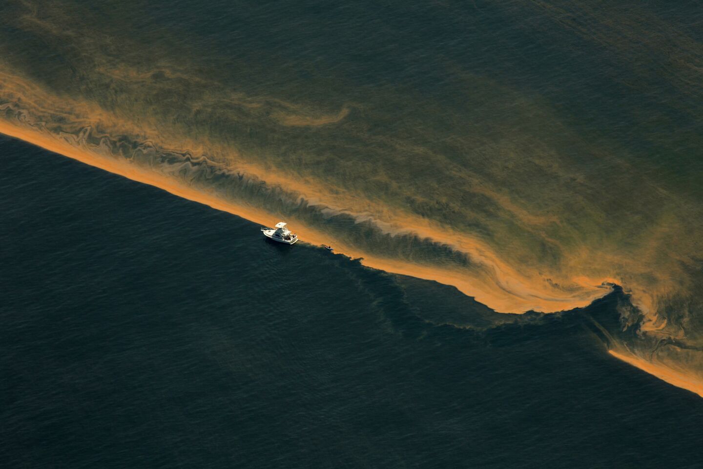 A boat makes its way along the edge of the oil spill in the Gulf of Mexico near the Chandeleur Islands on May 5, 2010. Oil reached the islands the following day, marking the first time it reached shore.