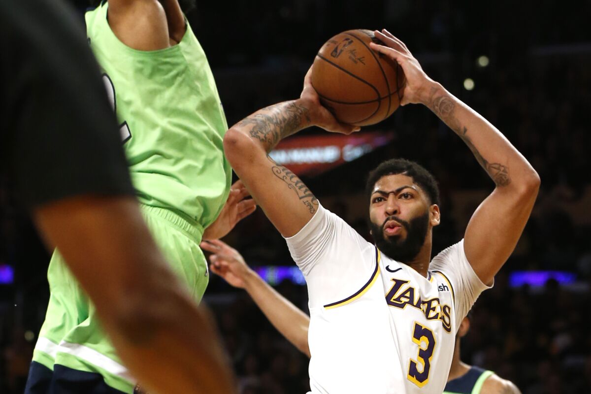 Lakers star Anthony Davis takes a shot against the Timberwolves.