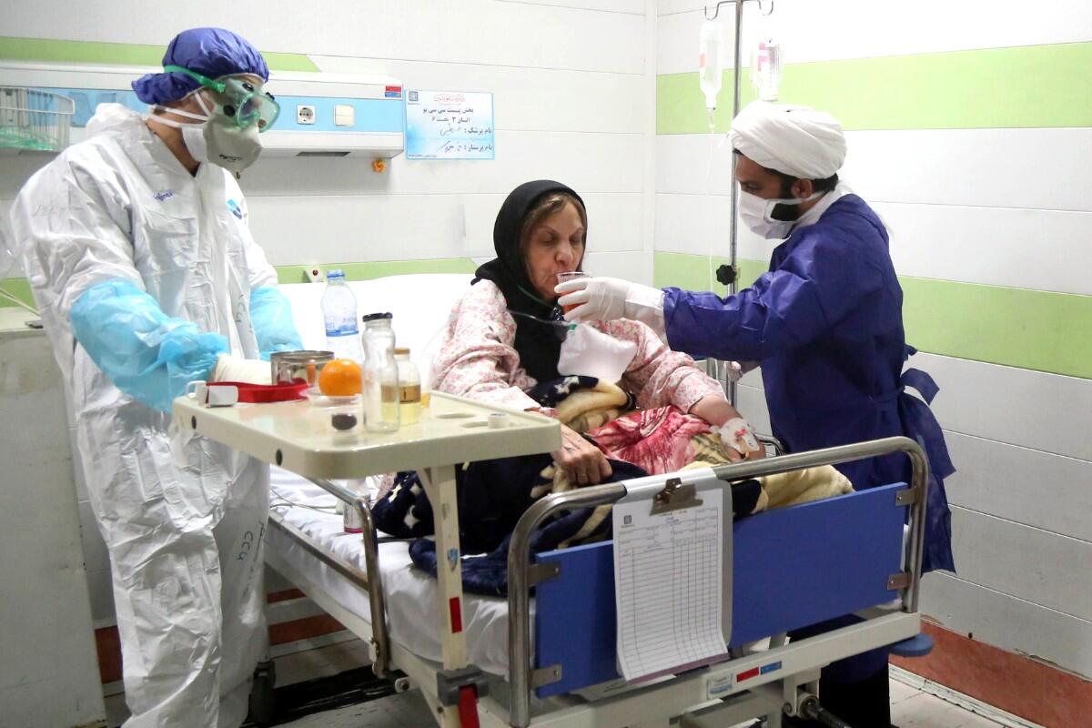 A patient infected with the new coronavirus is treated at a hospital in Qom, Iran.