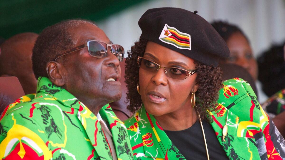 President Robert Mugabe and his wife, Grace, attend a youth rally in June in Marondera, Zimbabwe.