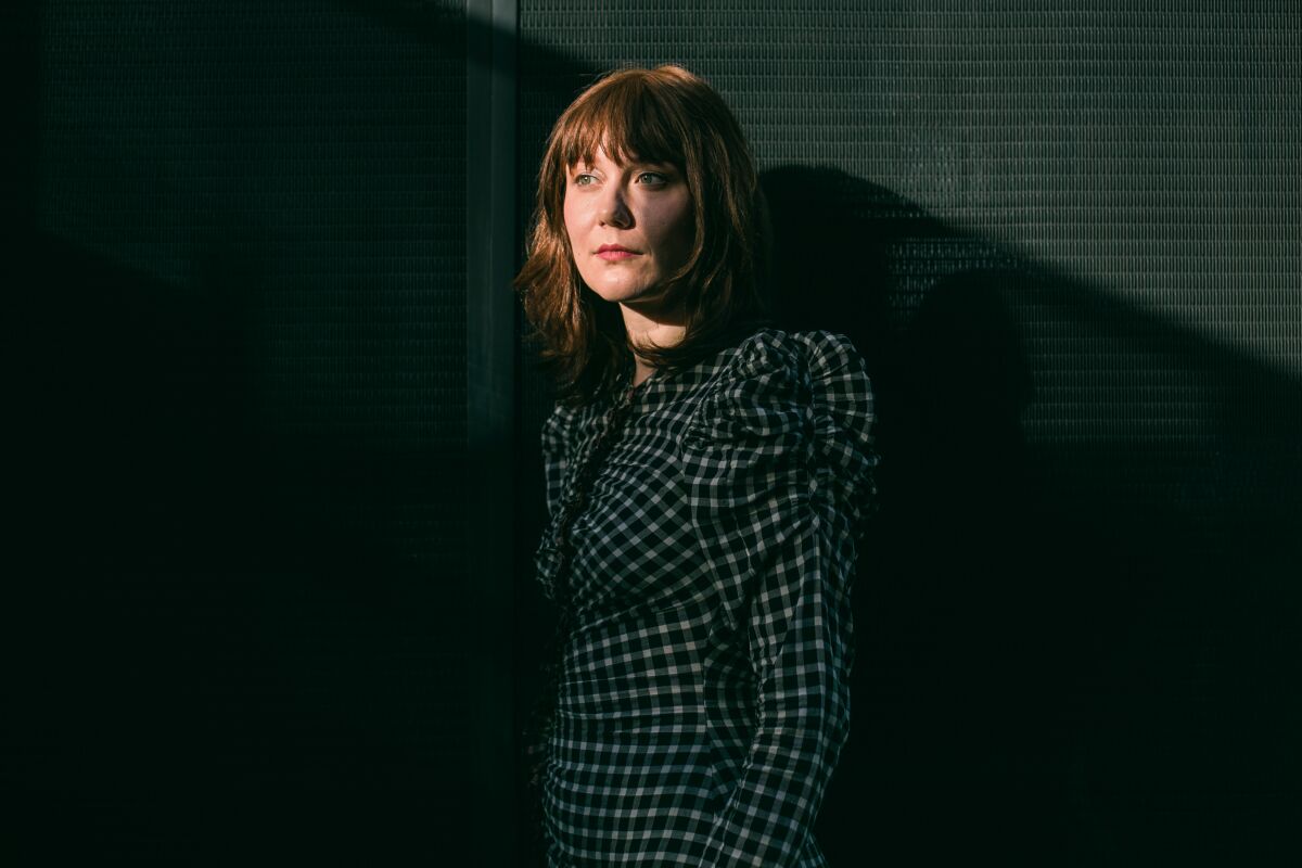 A woman in a checked dress