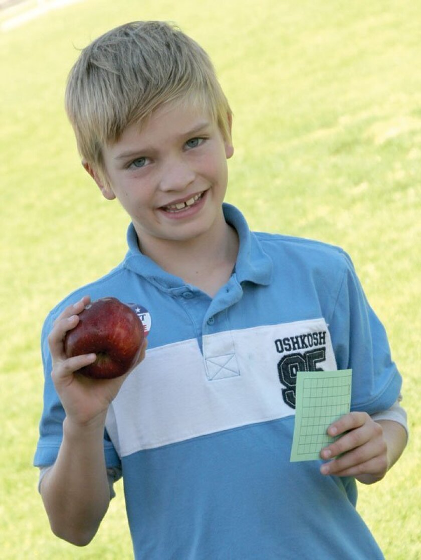Jacob Gaines (with apple and sticker that says 'I Elect to be Drug Free'