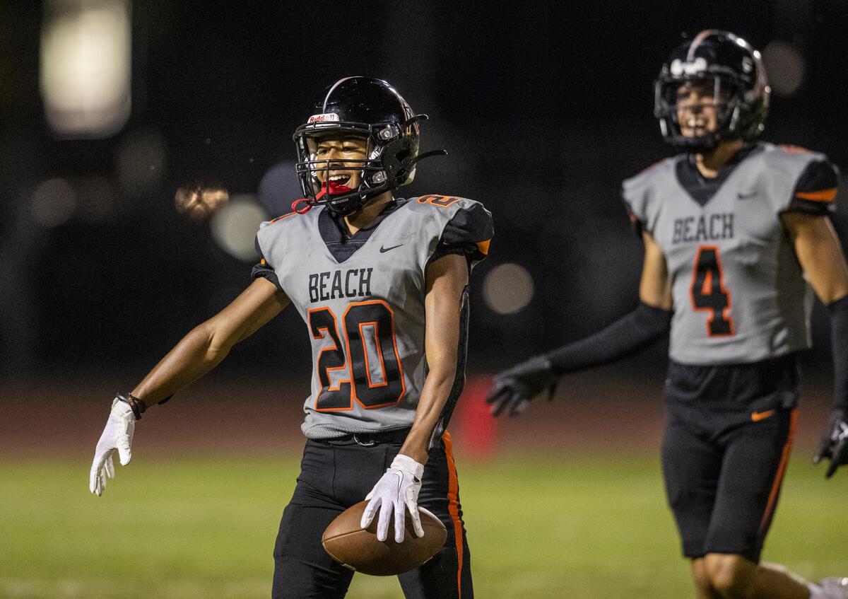 Huntington Beach's Musashi Ray celebrates after intercepting a pass during a game against Mayfair on Friday.