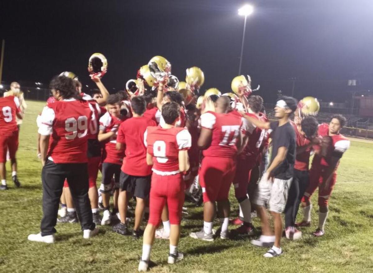 Taft football players celebrate on the field.