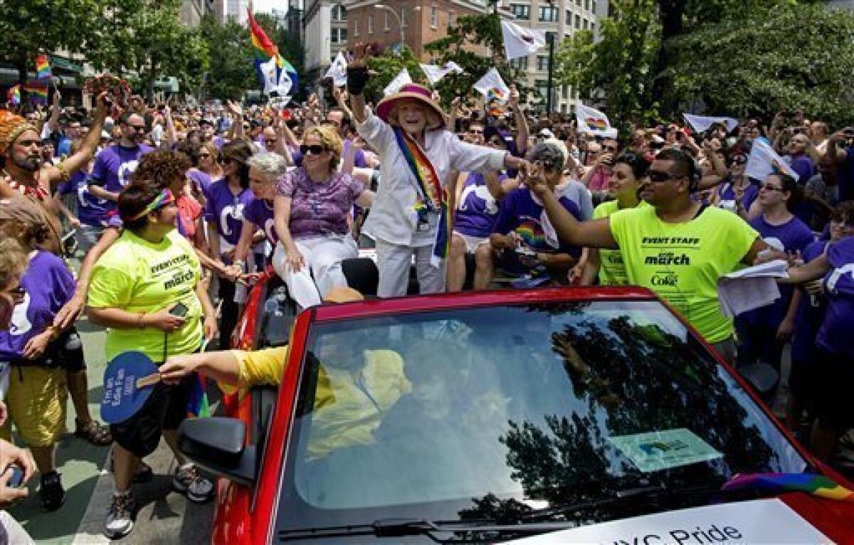 Grand marshal Edith Windsor, the 84-year-old woman at the center of the U.S. Supreme Court decision granting gay couples federal marriage benefits, is surrounded by well-wishers at the Gay Pride parade in New York.