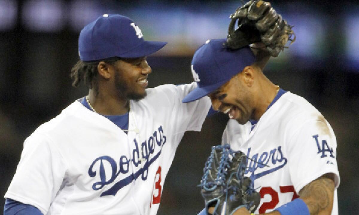 Dodgers shortstop Hanley Ramirez, left, and center fielder Matt Kemp celebrate after the team's 6-2 win over the San Francisco Giants on Sunday.