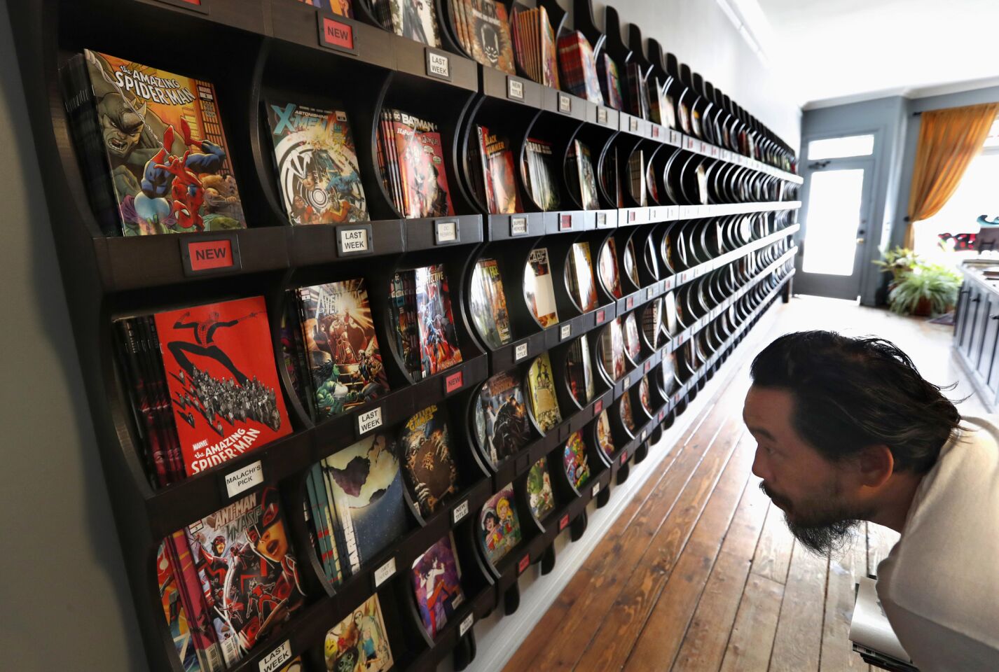 Artist David Choe of Koreatown looks at Marvel comic books for sale at Secret Headquarters on Sunset Boulevard in Los Angeles on July 11.