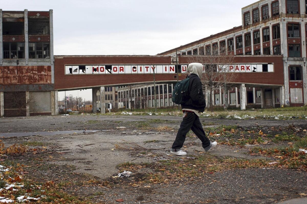 Detroit filed for Chapter 9 bankruptcy protection. Above: A person walks past the remains of the Packard Motor Car Company.