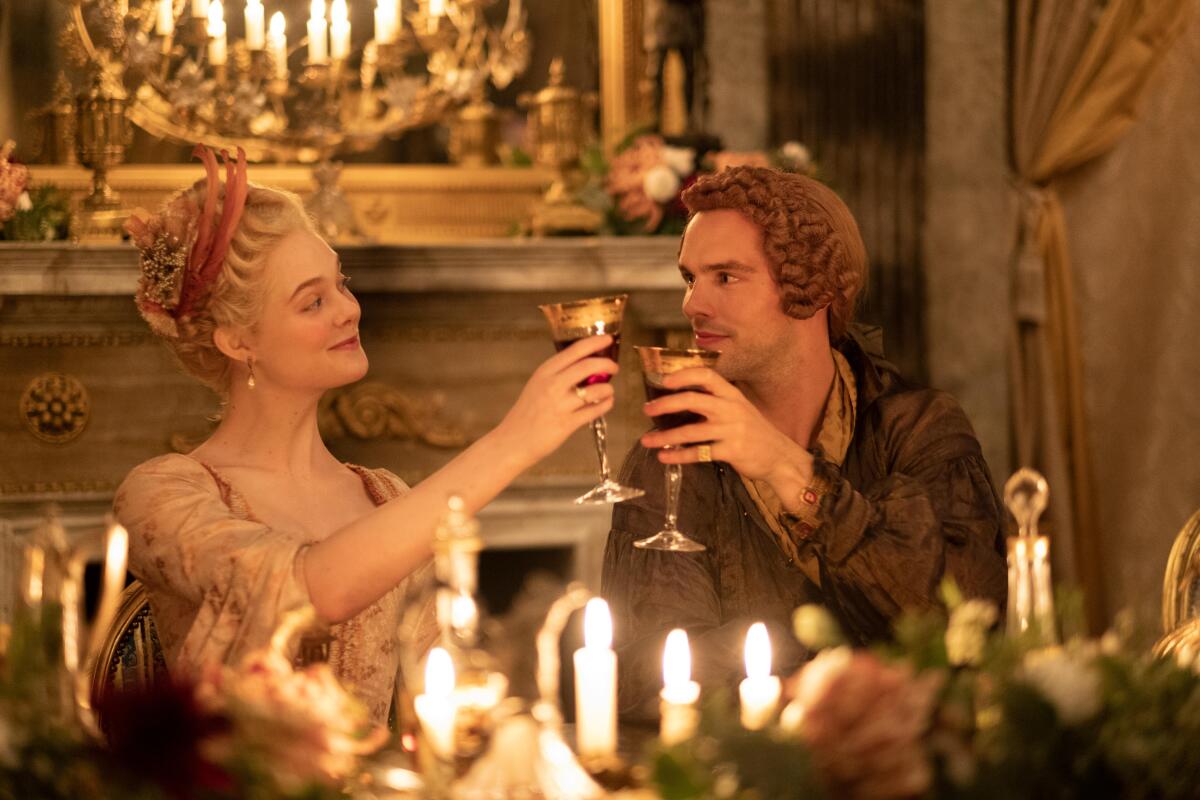 Catherine (Elle Fanning) shares a toast with husband Peter III (Nicholas Hoult) in "The Great."