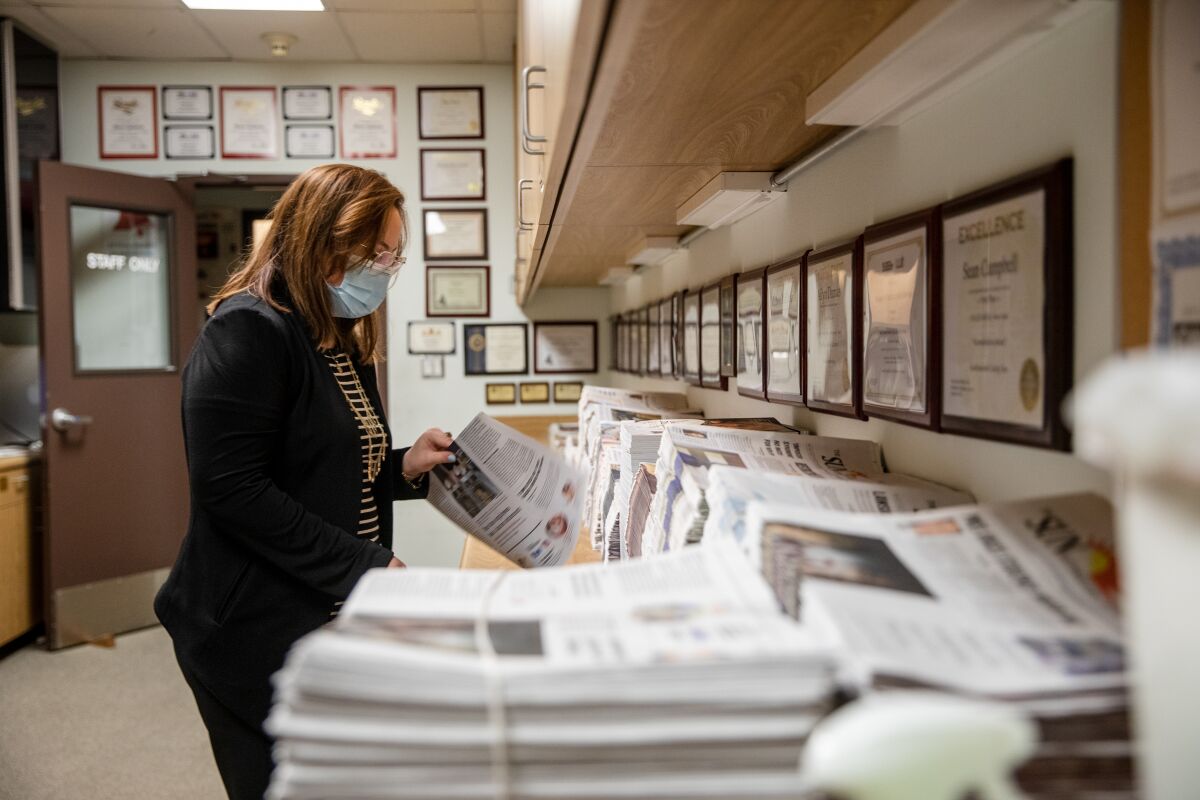 Julia Woock, editor-in-chief of The Southwestern College Sun, gathers newspapers in the archive of the newsroom last week.