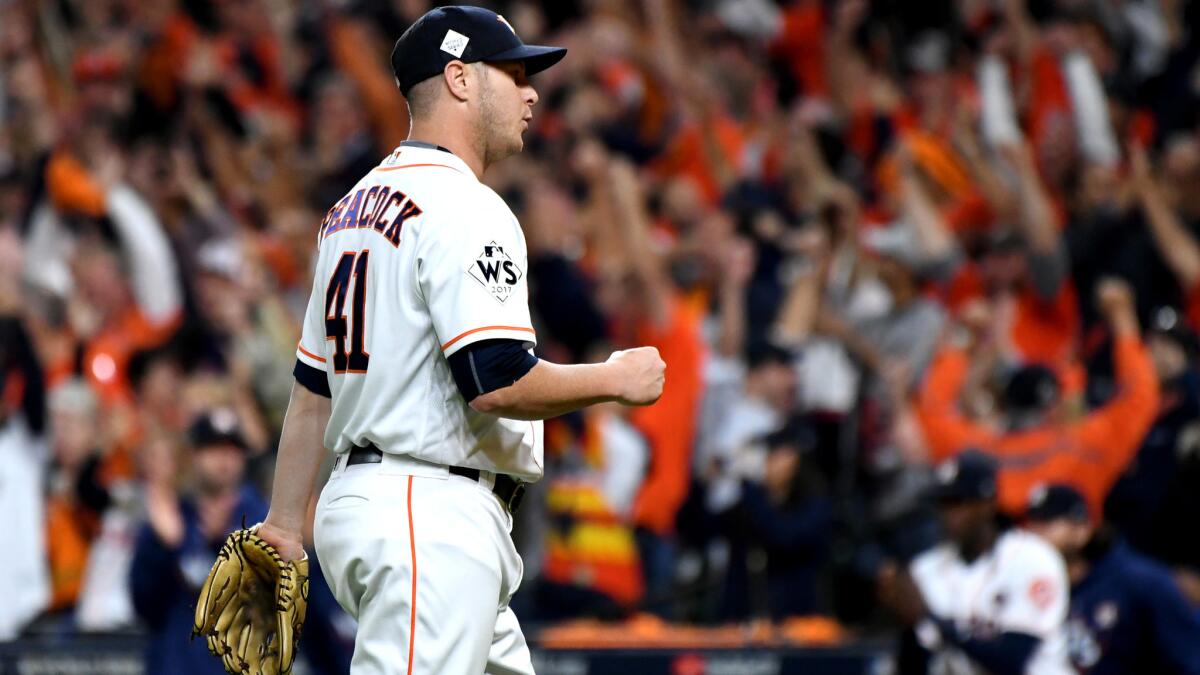 Astros relief pitcher Brad Peacock pumps his fist after recording the final out against the Dodgers in Game 3.