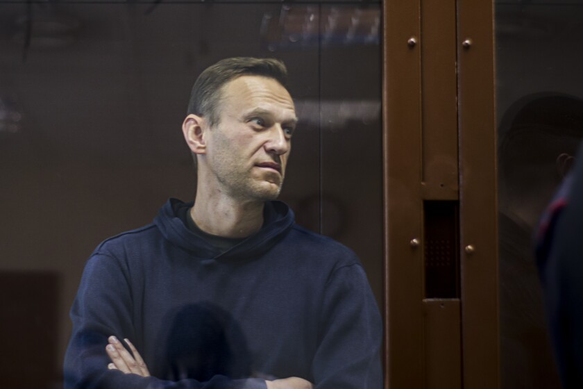 In this photo provided by the Babuskinsky District Court, Russian opposition leader Alexei Navalny stands in a cage during a hearing on his charges for defamation, in the Babuskinsky District Court in Moscow, Russia, Friday, Feb. 5, 2021. Russian opposition leader Alexei Navalny appeared in a Moscow court on Friday for the second time this week, this time on a charge of slandering a World War II veteran. The politician, who was ordered earlier this week to serve two years and eight months in prison, slammed the hearing as a "disgusting PR trial" intended by the Kremlin to disparage him. (Babuskinsky District Court Press Service via AP)