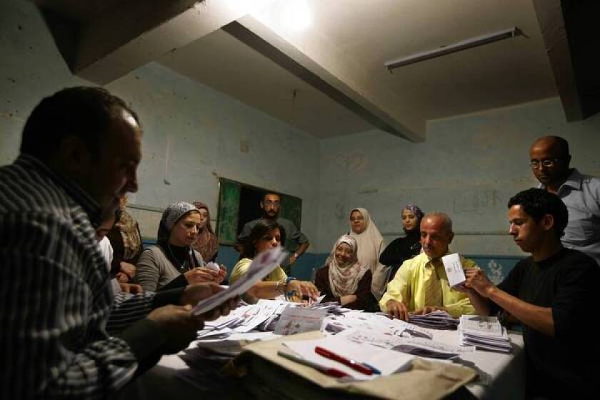Egyptian election workers count ballots from the presidential election at a school in Cairo.