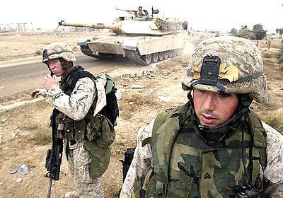 Marine Cpls. Sean Heffner, left, and Anibal Paz prepare to practice manuevering with tanks in anticipation of an assault on the insurgent-held city of Fallujah, Iraq.