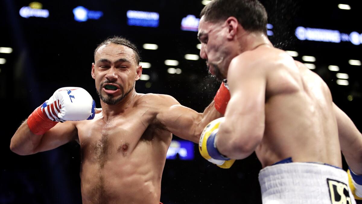 Keith Thurman lands a left to the face of Danny Garcia during the third round of their WBC welterweight championship fight on Saturday night.