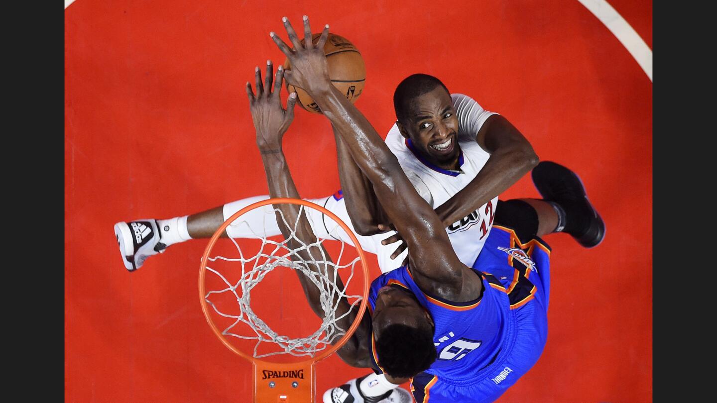Clippers forward Luc Mbah a Moute, top, has his shot blocked by Thunder forward Jerami Grant during the first half.