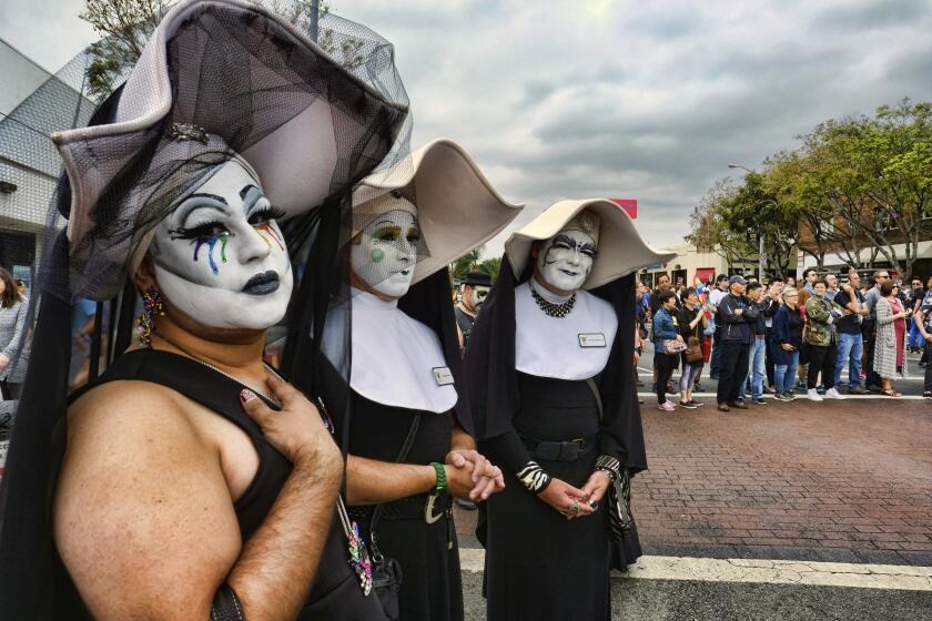 FILE - The Sisters of Perpetual Indulgence show their support during the gay pride parade in West Hollywood, Calif. on June 12, 2016. The Los Angeles Dodgers have removed a satirical LGBTQ+ group called the Sisters of Perpetual Indulgence from the team’s annual Pride Night after opposition from conservative Catholic groups. The team announced Wednesday, May 17, 2023, that the group, which primarily consists of men dressed as nuns, wouldn't receive an award during the June 16 event, citing the “strong feelings” of people who were offended. (AP Photo/Richard Vogel, File)