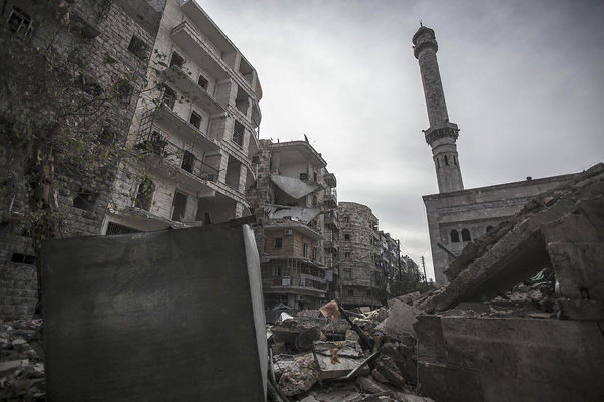 A mosque minaret still stands amid rubble from damaged buildings after an aircraft strike hit the mosque one week ago in the Tarik al-Bab neighborhood, southeast of Aleppo, Syria.