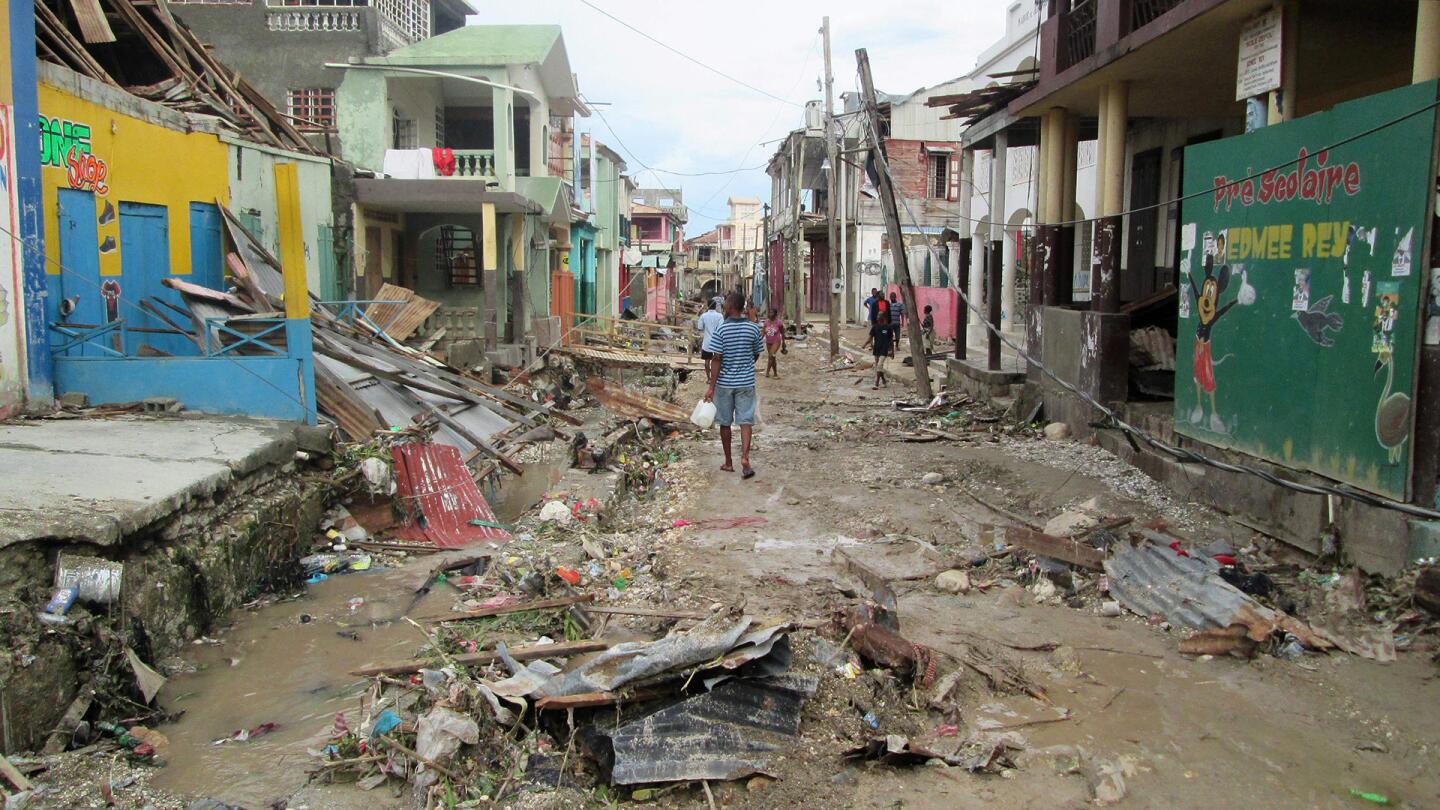 This handout photo obtained from the Agency for Technical Cooperation and Development Assistance on October 7, 2016 shows a man walking through the devasted town of Jeremie, west Haiti, following Hurricane Matthew.