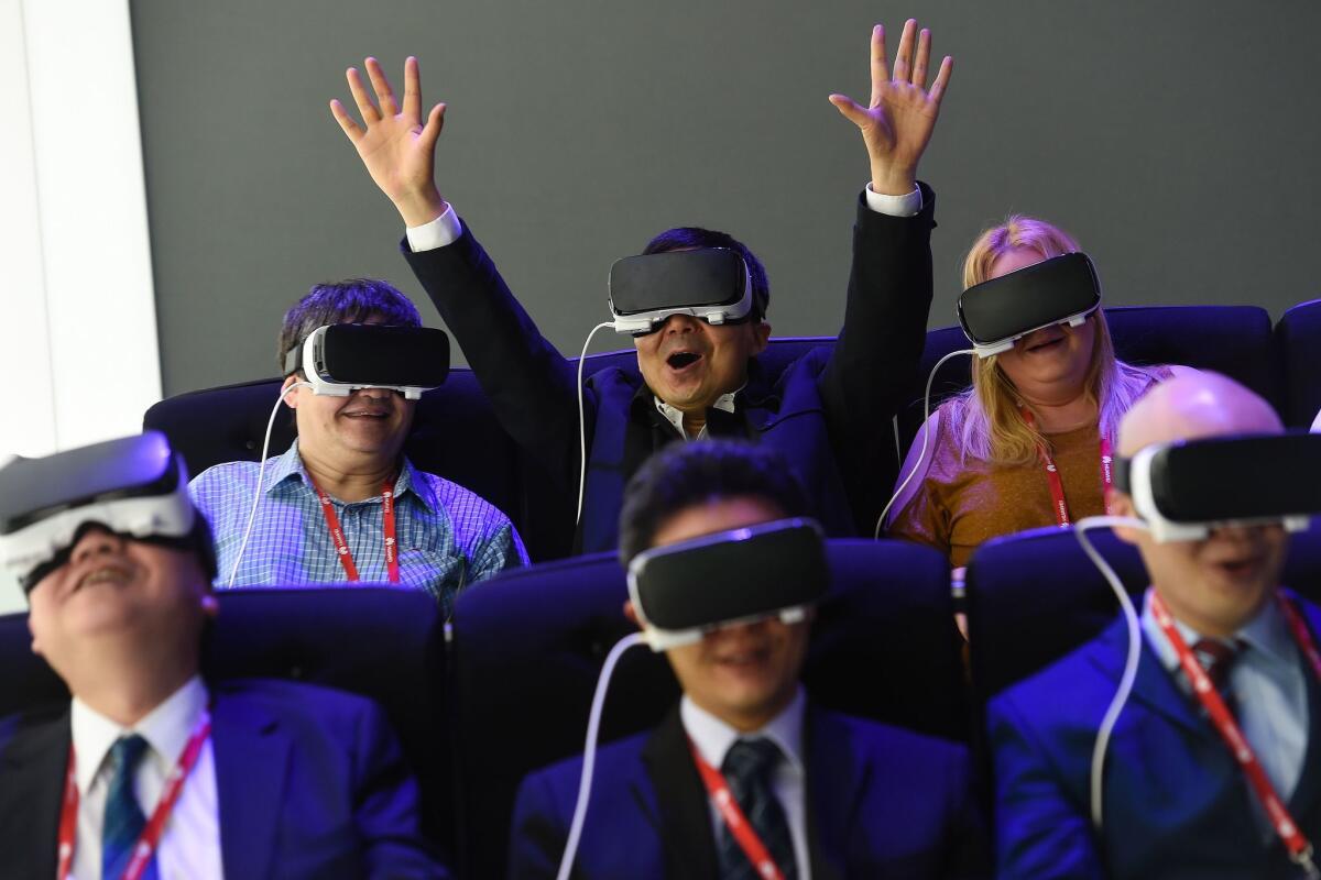 Visitors test the new Oculus VR virtual device at the Samsung stand during the Mobile World Congress in Barcelona on Feb. 22.