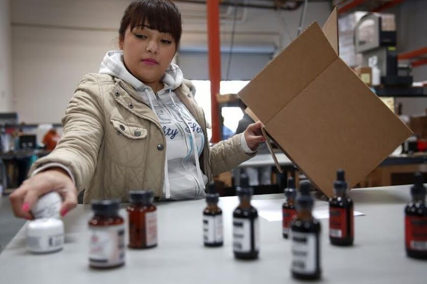 Medical Marijuana Inc. employee Celina Mejia prepares products for shipping at the company’s Poway facility.