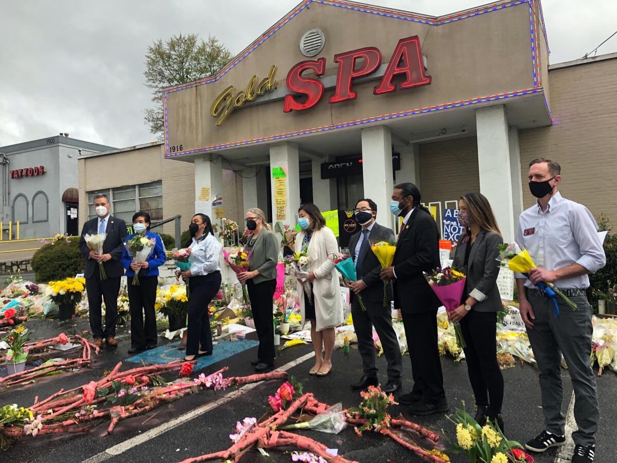 Elected officials visit a memorial outside Gold Spa in Atlanta.