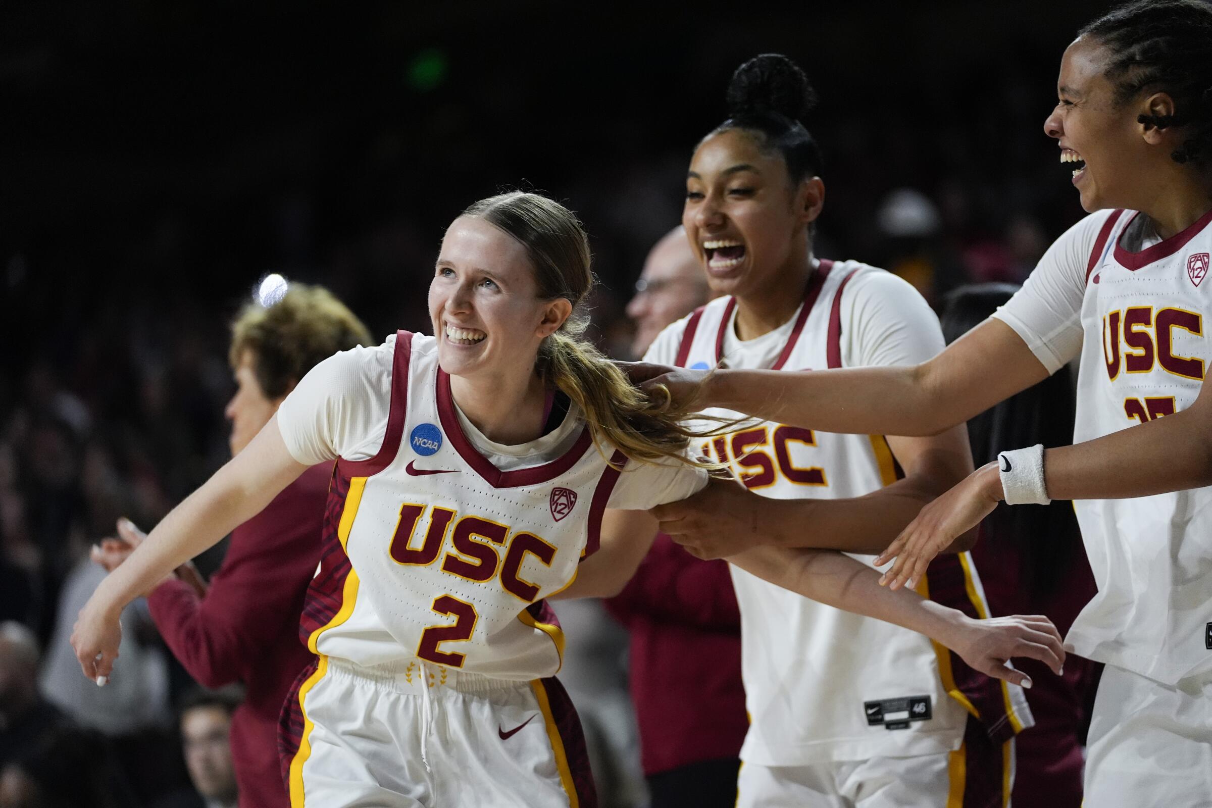 USC guard India Otto, left, celebrates with teammates JuJu Watkins, center, and McKenzie Forbes after scoring on Saturday.