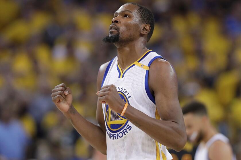 FILE - In this June 12, 2017 file photo, Golden State Warriors forward Kevin Durant reacts after scoring against the Cleveland Cavaliers during the second half of Game 5 of basketball's NBA Finals in Oakland, Calif. A person with knowledge of the situation tells The Associated Press that Durant has agreed to terms on a two-year deal worth about $53 million to remain with the Golden State Warriors. The deal calls for about $25 million in the first year with a player option for the second season. The person spoke on condition of anonymity because the contract cannot be signed until Thursday, July 6, 2017. (AP Photo/Marcio Jose Sanchez, File)