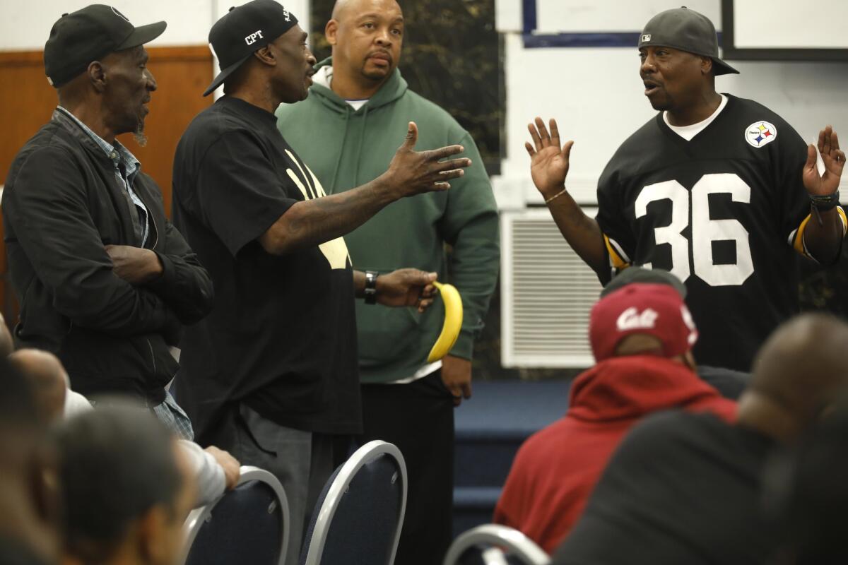 Frederick "Gangster" Staves of the Santana Blocc Crips, second from left, makes a point to Robinson "G-Nutt" Lonnell of the 151 Pirus, far right, at a gang peace summit in Compton.