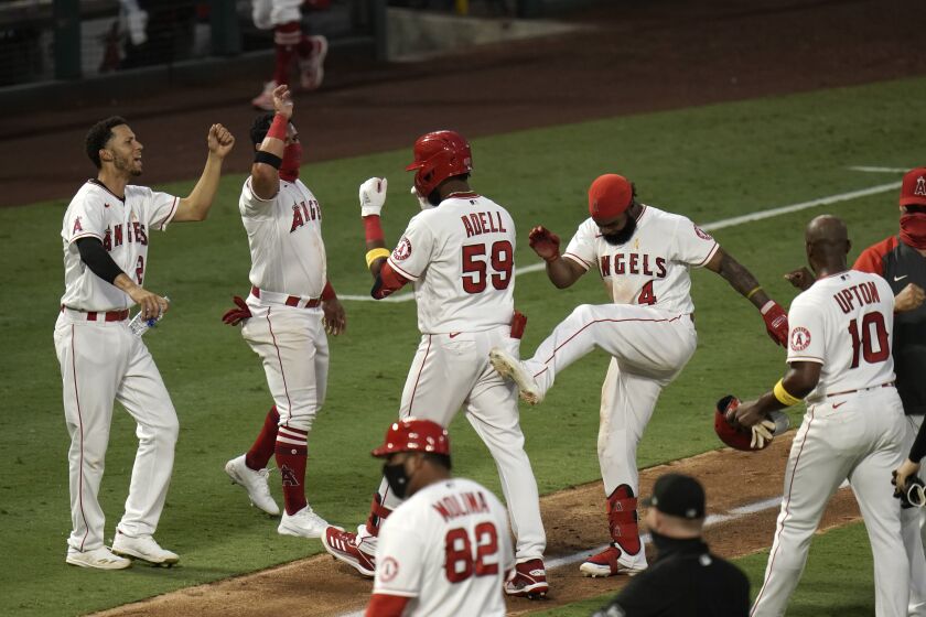 The Angels' Jo Adell and teammates celebrate his seventh-inning, walk-off single Sept. 5, 2020, against the Astros.