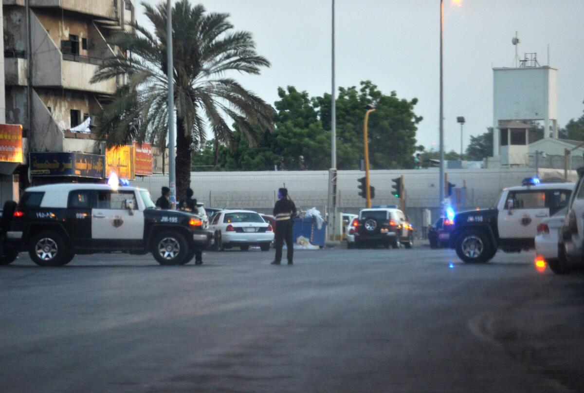 Saudi police stand guard at the site where a suicide bomber blew himself up early Monday near the American Consulate in the Red Sea city of Jidda.