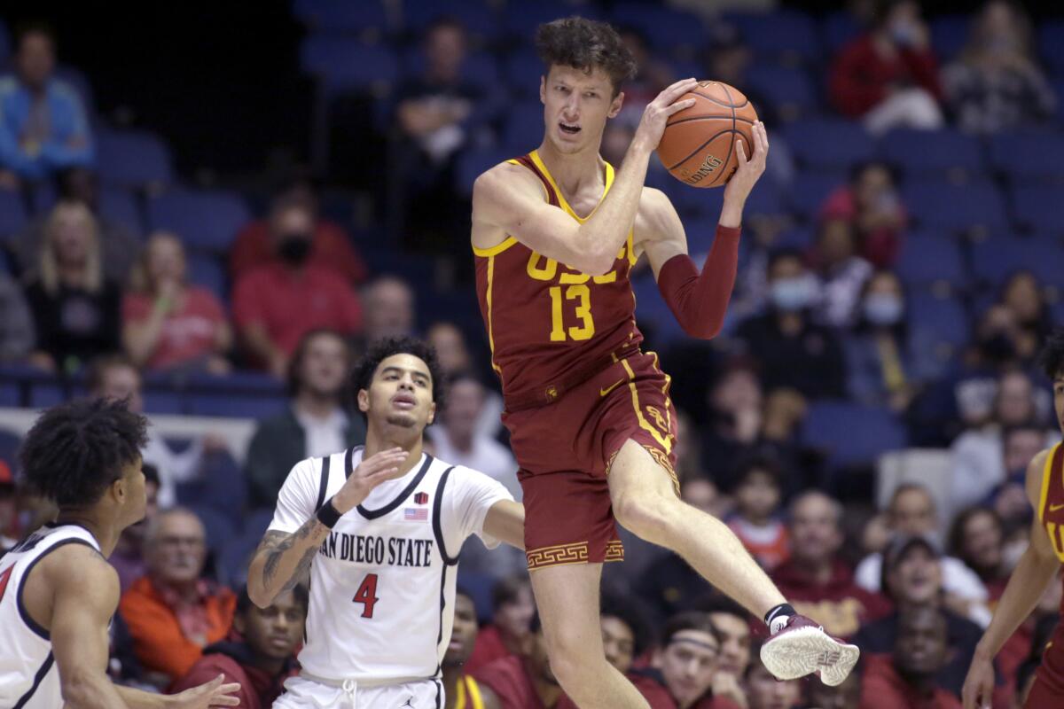 USC's Drew Peterson (right) pulls down a loose ball in front of SDSU's Trey Pulliam during the Trojans' 58-43 win.
